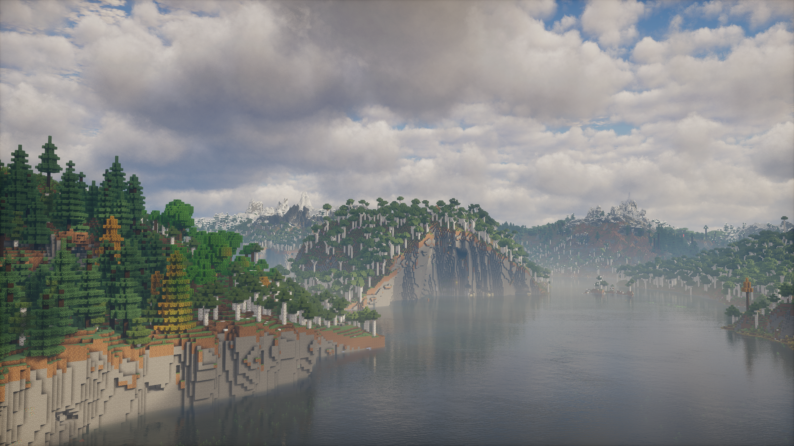 A wide lake surrounded by forests and mountain ranges in The Frontier