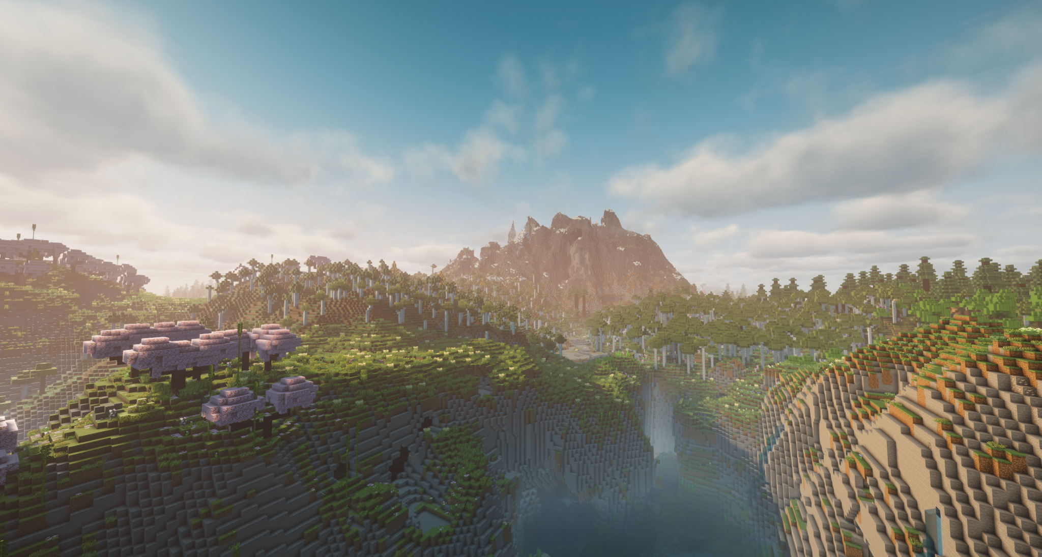 A broad river valley stretching toward distant mountains